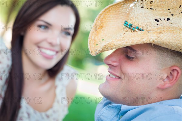 Happy romantic caucasian couple talking in the park