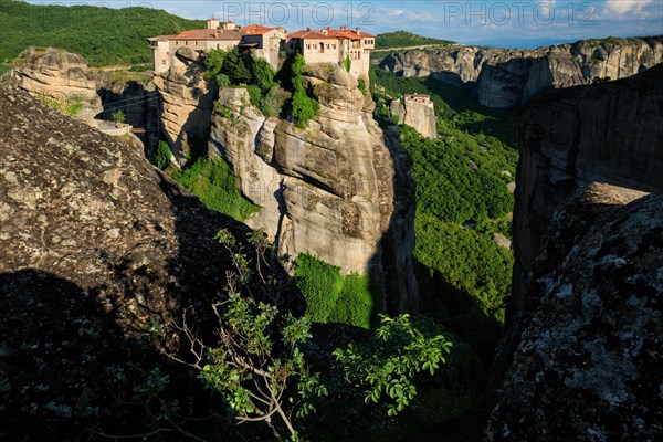 Monastery of Varlaam monastery and Monastery of Rousanou in famous greek tourist destination Meteora in Greece on sunset with scenic scenery landscape