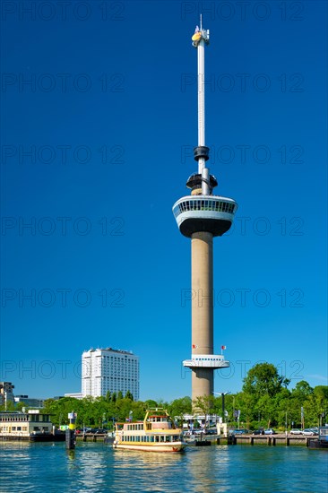 Rotterdam cityscape with Euromast observation tower and tourist boat on Nieuwe Maas river