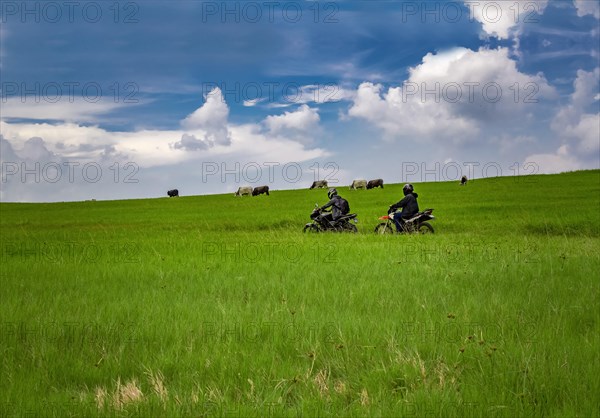 Young man on his motorcycle traveling through the countryside with copy space