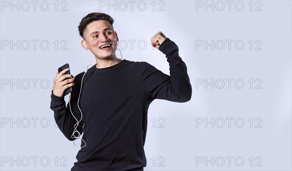 Guy with headphones raising his hand in victory sign