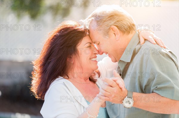 Happy middle aged couple enjoy A romantic slow dance outside