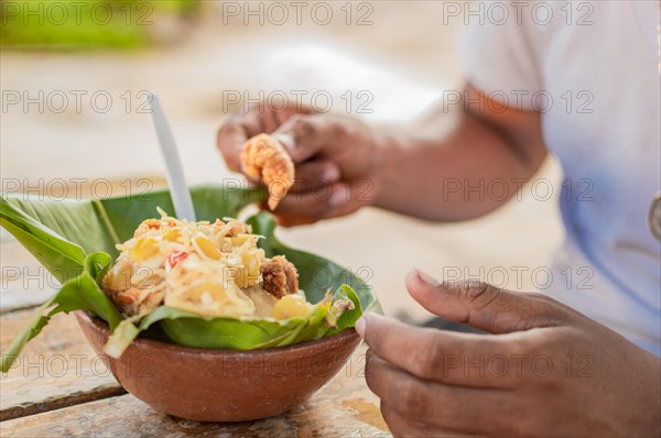 Close-up of a person eating vigoron