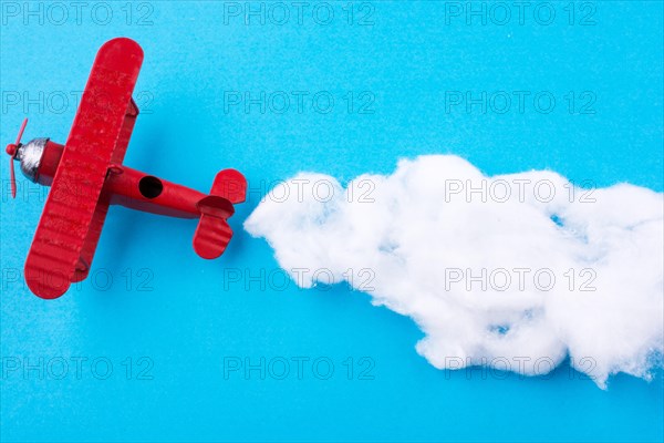 Retro styled little red model airplane in sky