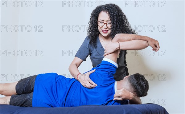 Female doctor with patient undergoing back treatment