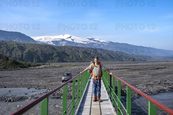 Hikers on a bridge over the river Krossa