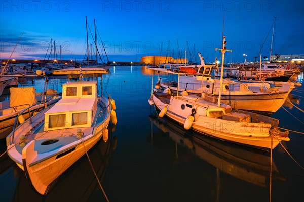 Venetian Fort Venetian fortress of Koules Castello a Mare castle in Heraklion and moored Greek fishing boats in port