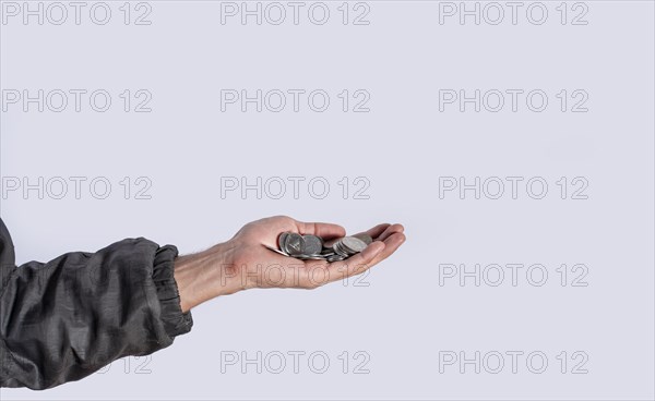 Hands with several coins in isolated background