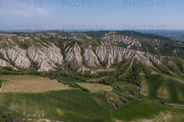 Aerial view of a hilly landscape with erosion valleys