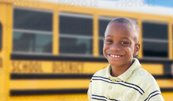 Young african american boy near school bus