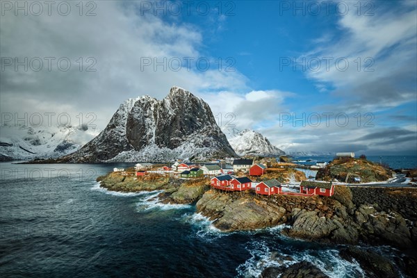 Hamnoy fishing village with red rorbu houses in Norwegian fjord in winter