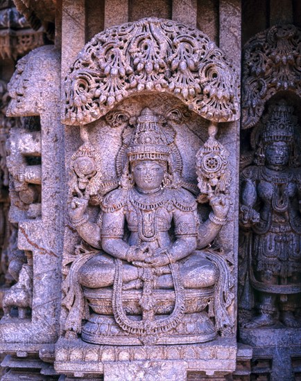 Close up of stone sculpture of dancing Lakshmi in Hoysala architecture at Somnathpur