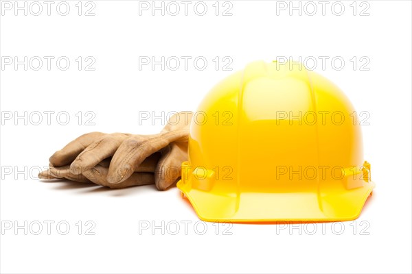 Yellow hard hat and gloves isolated on white