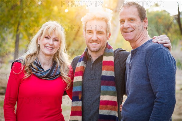 Loving middle aged parents and young son portrait outdoors