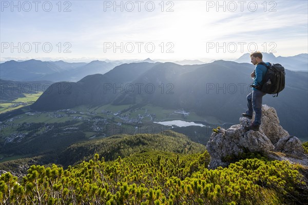 Hiker standing on a rock between mountain pines