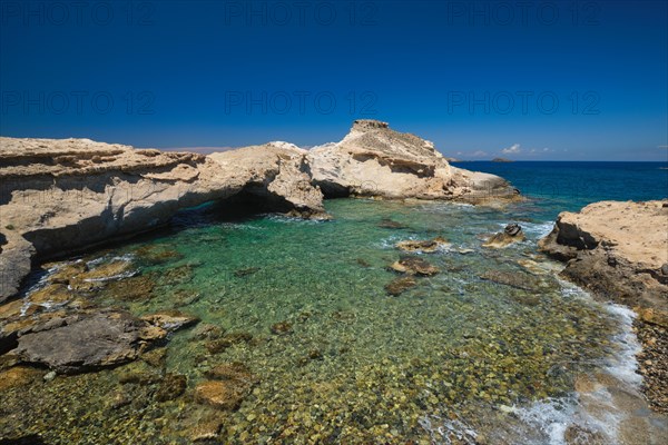 The beach of Agios Konstantinos with crystal clear turquoise water and rock formations in Milos island