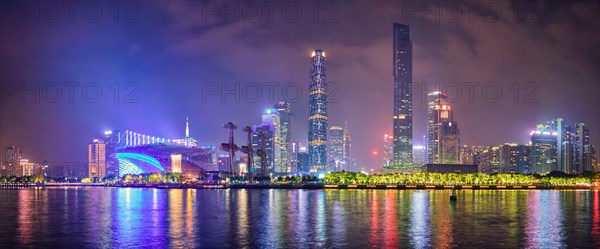 Guangzhou cityscape skyline over the Pearl River illuminated in the evening. Guangzhou