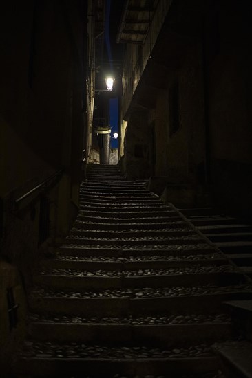 Narrow dark alley with stairs in Cannobio
