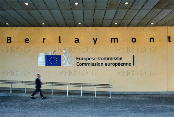 Blurred man walking in front of The Berlaymont building in Brussels