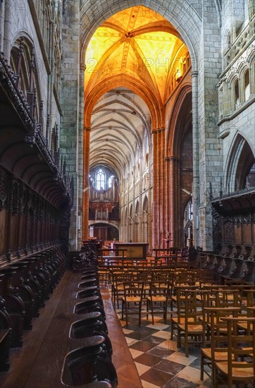 View from the choir with choir stalls into the nave with organ