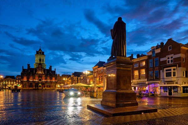 Delft City Hall and Delft Market Square Markt with Hugo de Groot Monument in the evening