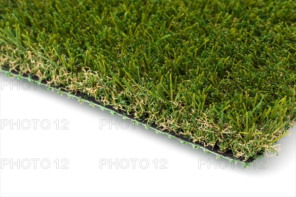 Section of artificial turf grass on white background