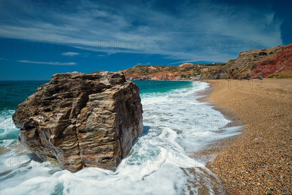 Rocks on Paleochori beach and waves of Aegean sea