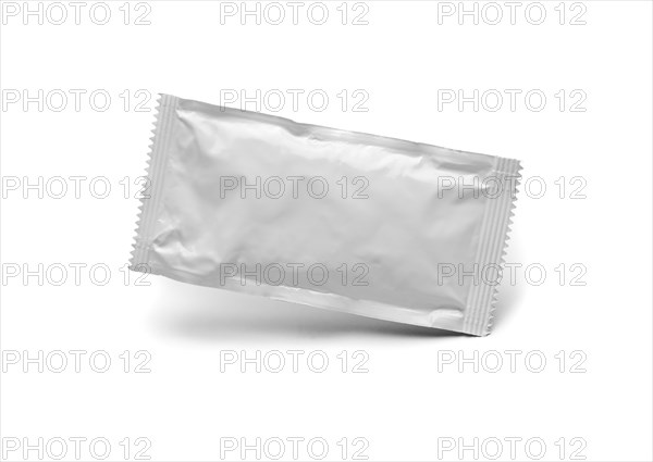 Blank white condiment packet floating isolated on white background