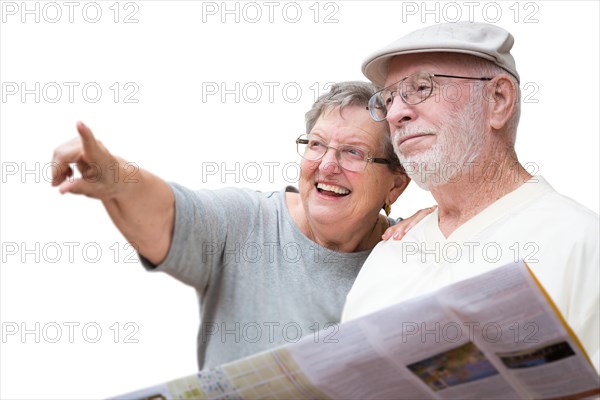 Happy senior adult couple with brochure pointing isolated on a white background