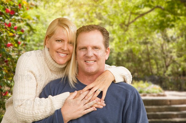 Happy attractive caucasian couple portrait in the park