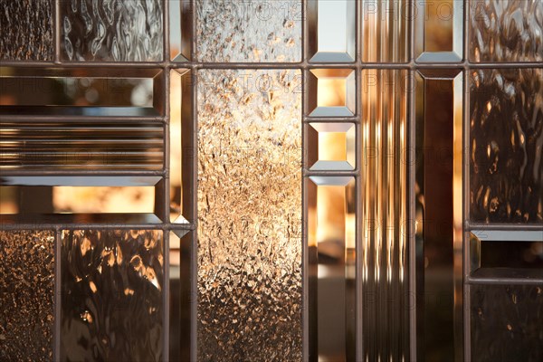 Beautiful beveled glass window with warm reflections
