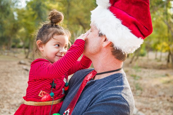 Festive grandfather and mixed-race baby girl outdoors