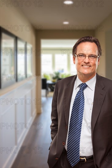 Smiling businessman in hallway of new house