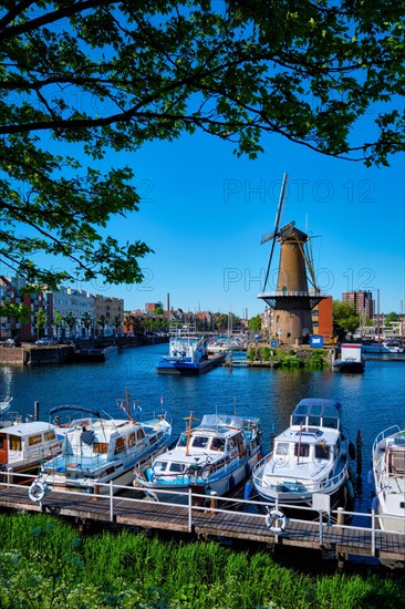 View of the harbour of Delfshaven with the old grain mill known as De Destilleerketel