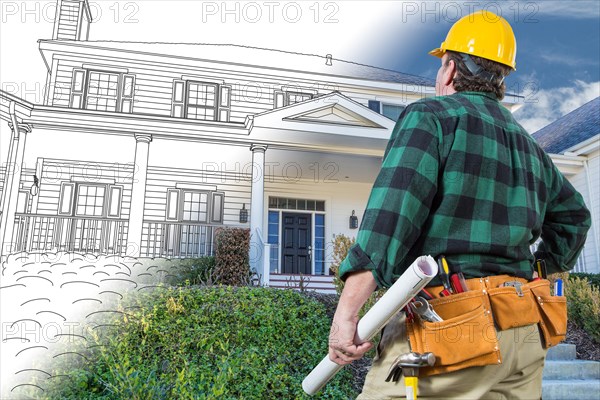 Male contractor with hard hat and tool belt looking at custom house drawing photo combination on white