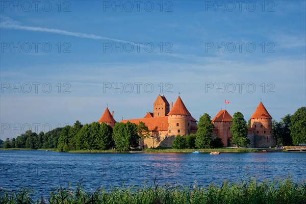 Trakai Island Castle in lake Galve with boats and yachts in summer day with beautiful sky