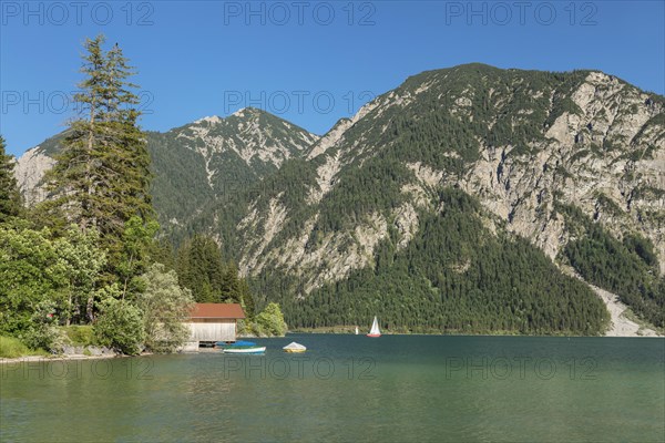 Sailing boats in summer on the Plansee lake near Reutte