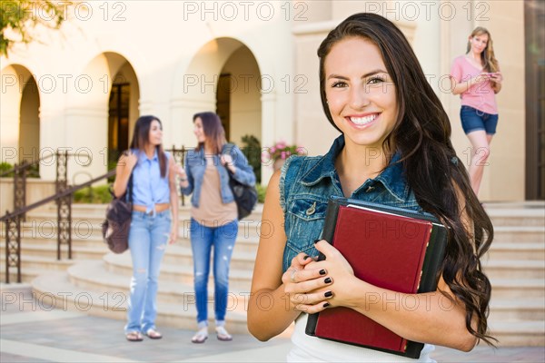 mixed-race young girl student with school books on campus