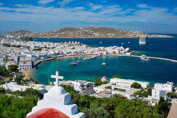 View of Mykonos town Greek tourist holiday vacation destination with famous windmills