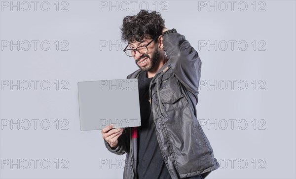 Young man with hand on head showing poster