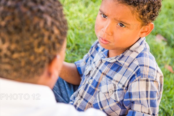 Happy african american father and mixed-race son playing at the park