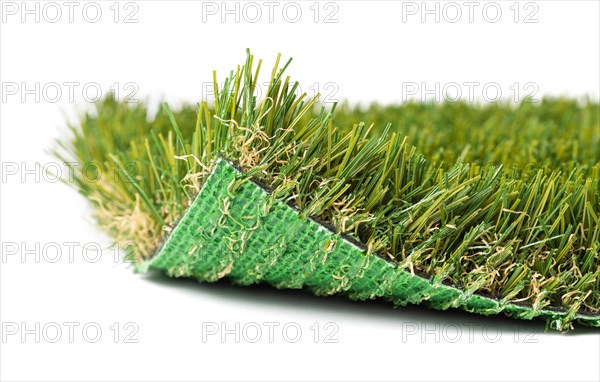 Flipped up section of artificial turf grass on white background