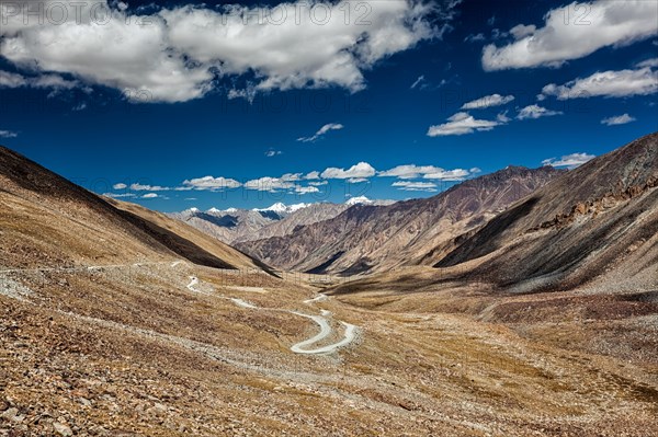 View of Karakoram range and road in valley from Kardung La