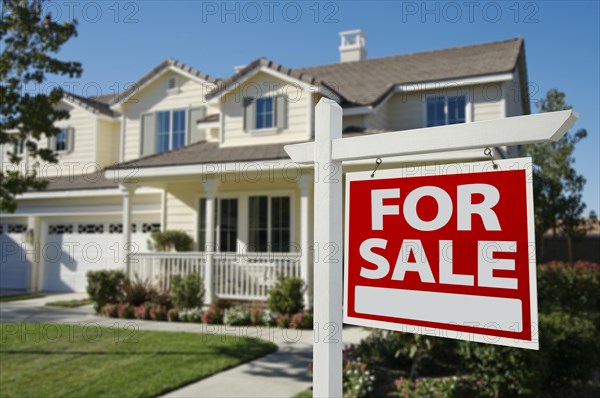 Home for sale sign in front of new house