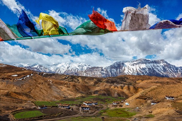 Buddhist prayer flags lungta with Om mani padme hum. . mantra written on them in sky over Comic Village. Spiti Valley