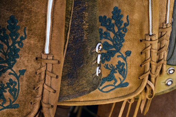 Embroidery and staghorn buttons on leather trousers