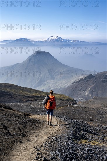 Hikers on hiking trail through volcanic landscape