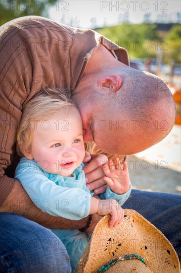 Adorable young family enjoys a day at the pumpkin patch