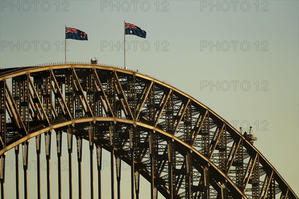 Flags on the Sydney Harbour Bridge at sunrise