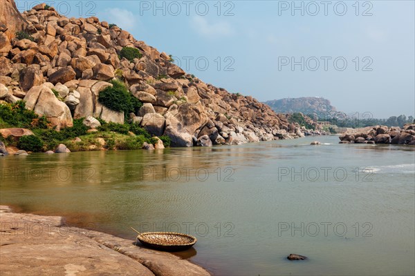 Traditional wickerwork coracle boat in Hampi on bank of Tungabhadra river